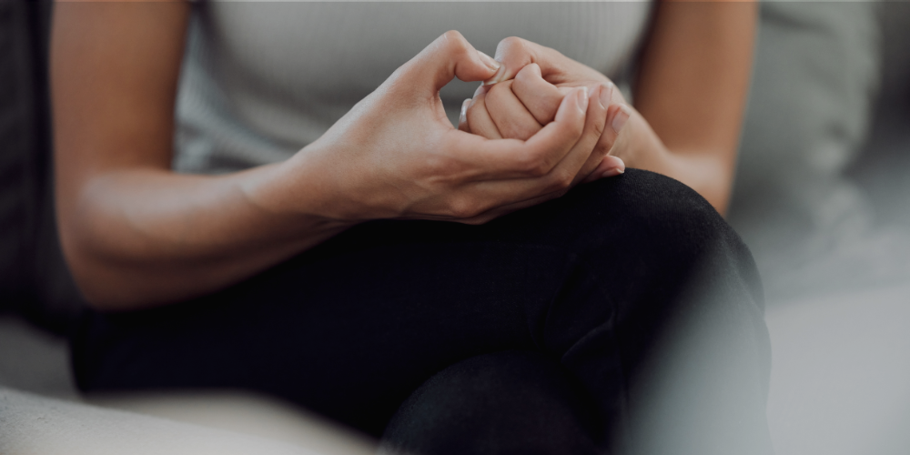 anxious woman picking fingernails