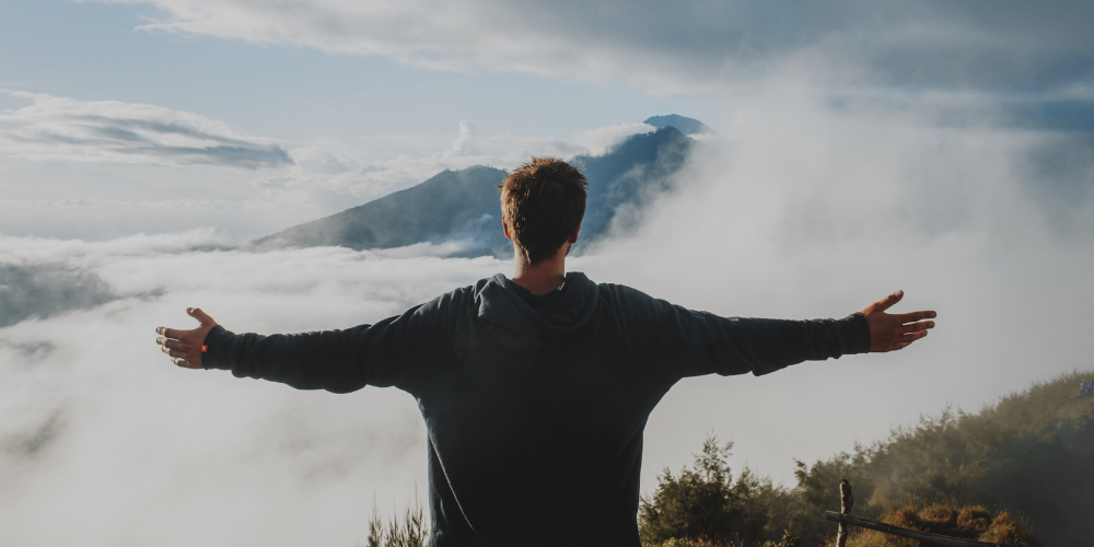 man on top of mountain