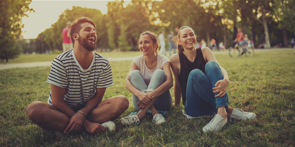 friends laughing on the grass