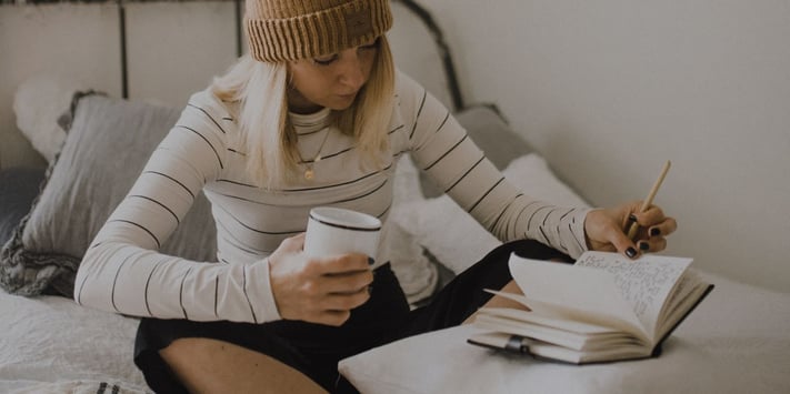 woman writing in a journal