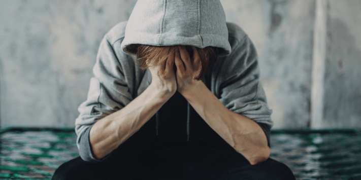 depressed man with head in hands
