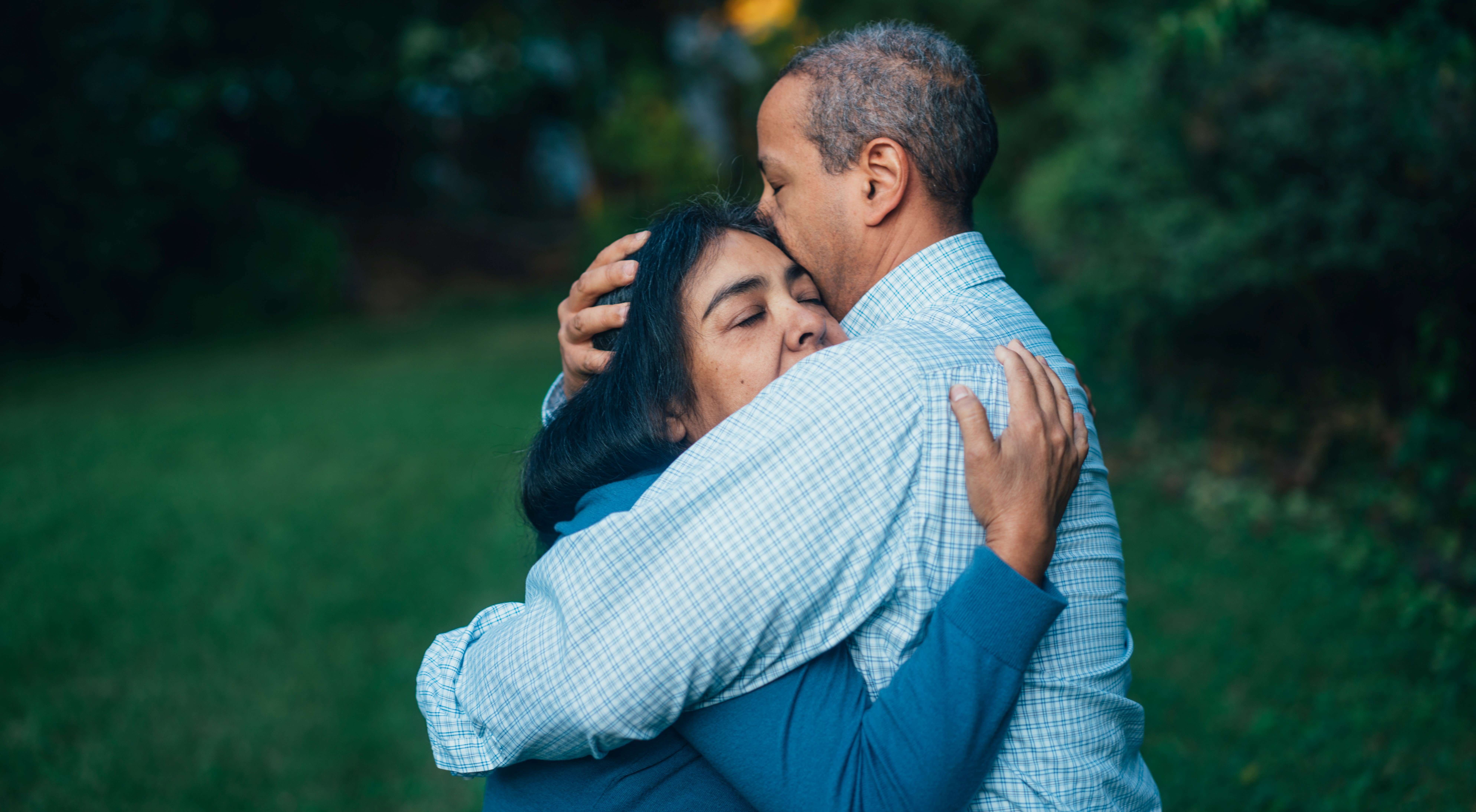 middle aged man and woman hugging