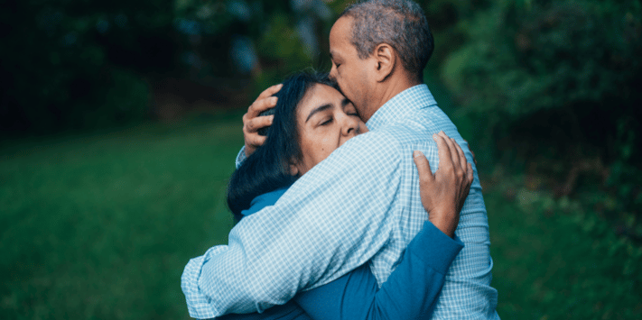 man and woman hugging