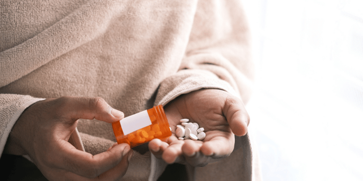 pouring pills into hand