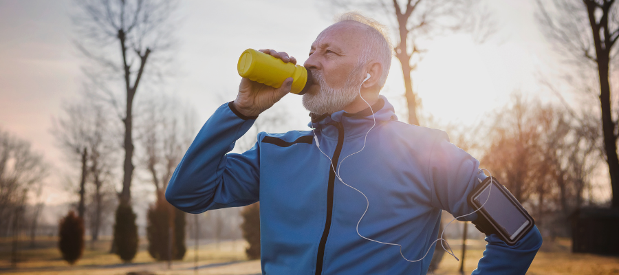 man drinking water on a run